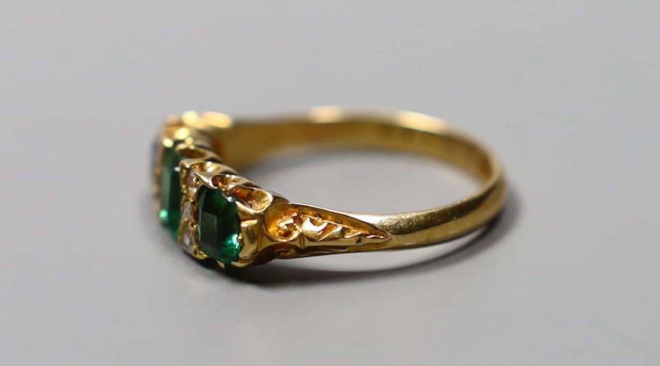 An Edwardian 18ct gold, thee stone green doublet and rose cut diamond chip set half hoop ring, size O, gross 4 grams.